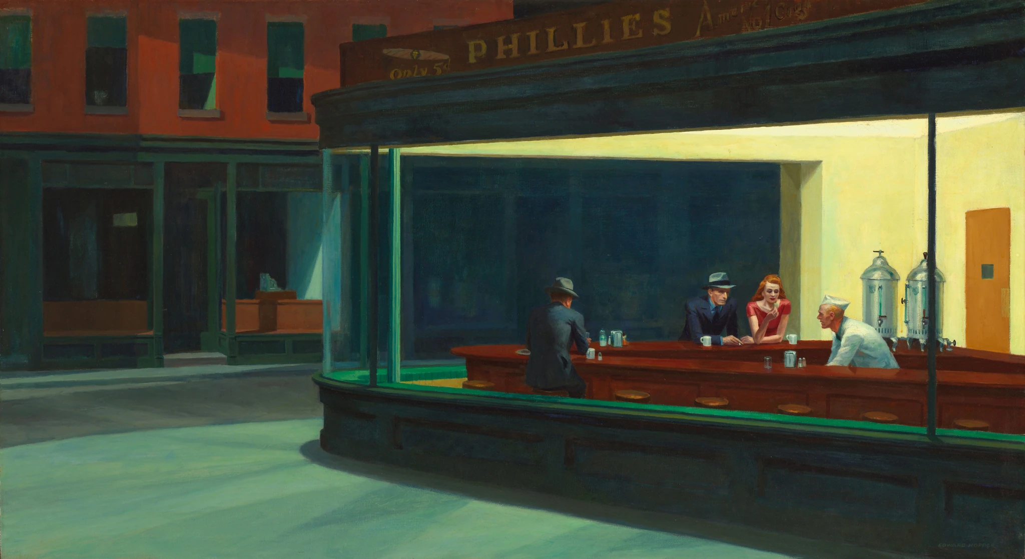 A brightly lit diner on a dark street, with three customers and a server at its curved counter.